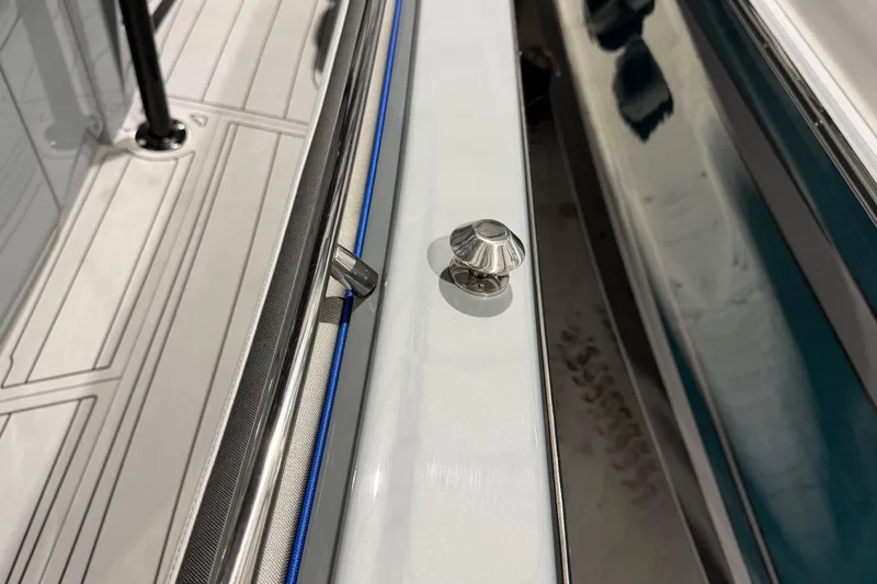 Slide: The Image of 2025 Nor-Tech 390 Sport Center Console deck detail with stainless steel fittings. - 44