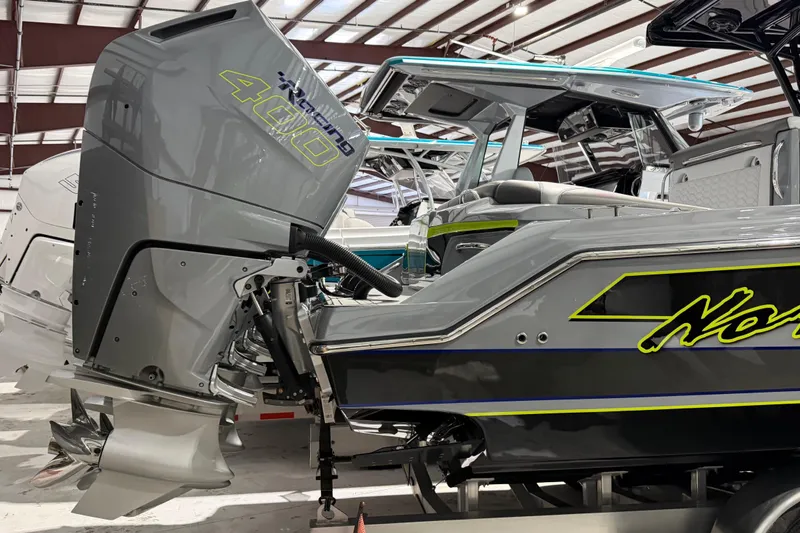 Slide: The Image of 2025 Nor-Tech 390 Sport Center Console with powerful outboard engine in a showroom. - 45