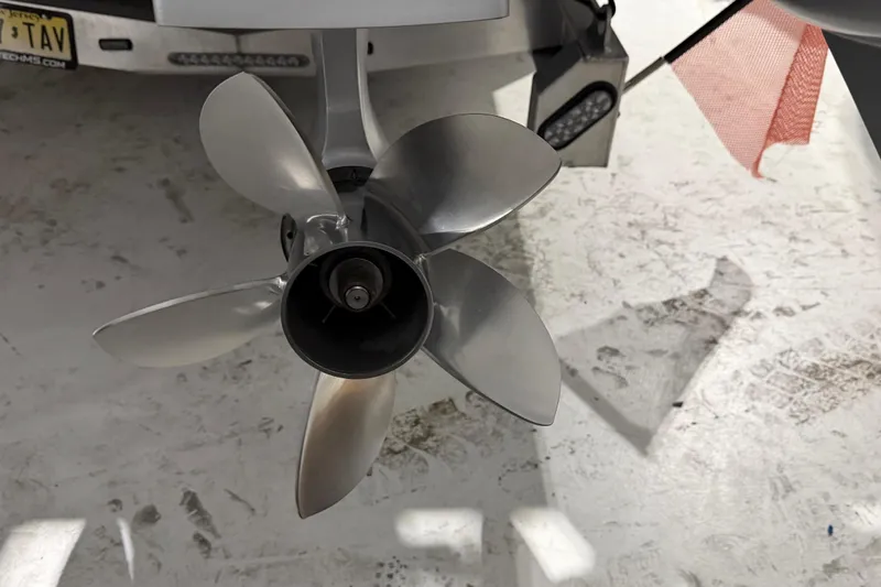 Slide: The Image of Propeller of 2025 Nor-Tech 390 Sport Center Console boat in a garage setting. - 48