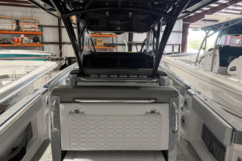 Slide: The Image of 2025 Nor-Tech 390 Sport Center Console boat interior in a showroom setting. - 7