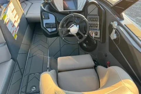 Slide: The Image of Interior of a 2026 Supreme S220 boat featuring modern steering and control panel. - 11
