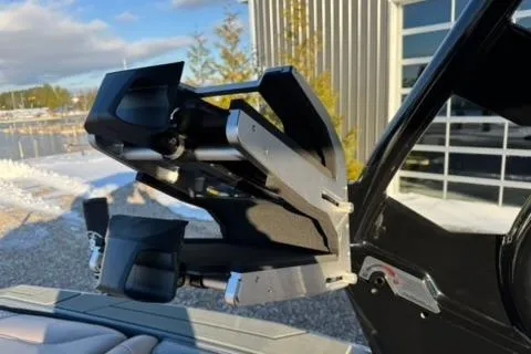 Slide: The Image of Supreme S220 2026 boat with advanced wakeboard tower in a sunny outdoor setting. - 16