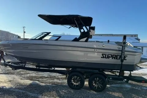 Slide: The Image of 2026 Supreme S220 boat on trailer, side view, sunny day. - 6