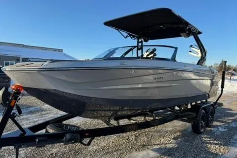 Slide: The Image of 2026 Supreme S220 boat on trailer, sleek design, black canopy, parked outdoors. - 7
