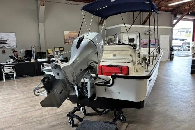 Slide: The Image of 2003 Boston Whaler 170 Montauk boat with outboard motor in showroom. - 10