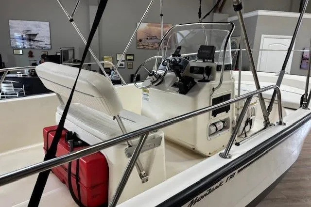 Slide: The Image of 2003 Boston Whaler 170 Montauk boat interior with steering console and seating. - 3