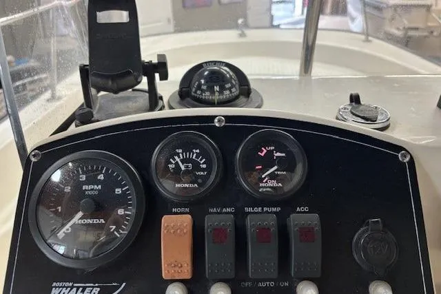 Slide: The Image of Dashboard of a 2003 Boston Whaler 170 Montauk boat with Honda gauges and controls. - 7