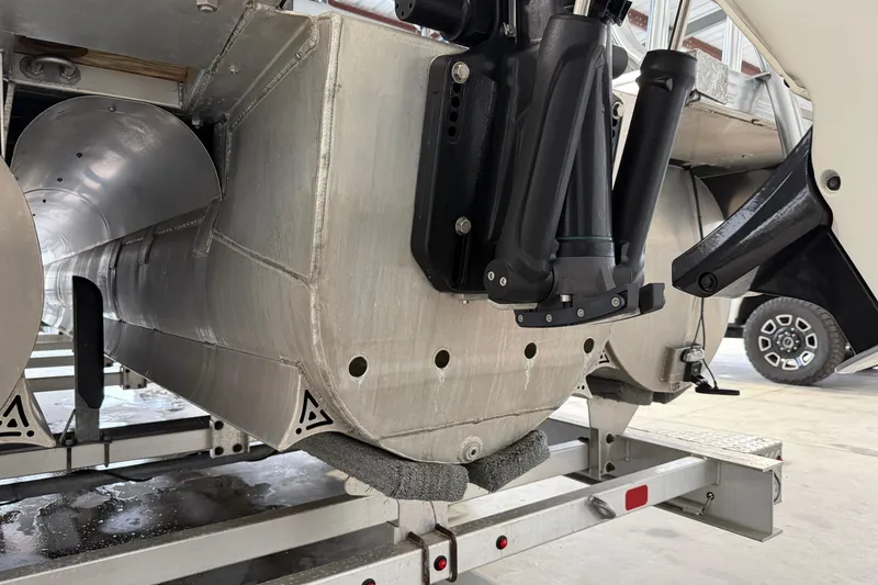 Slide: The Image of 2023 Aloha Pontoon PS 260 TT on trailer, showcasing aluminum pontoons and motor mount. - 101