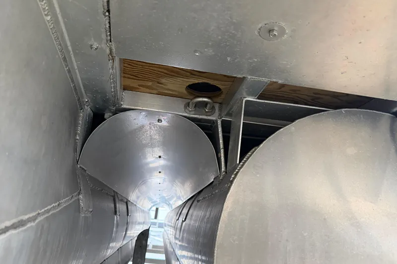 Slide: The Image of Underneath view of 2023 Aloha Pontoon PS 260 TT, showcasing metal structure and components. - 103