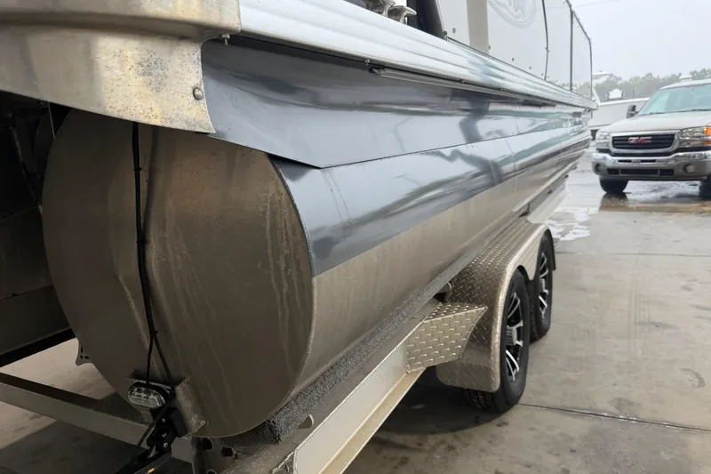 Slide: The Image of 2023 Aloha Pontoon PS 260 TT on trailer, showcasing sleek design and sturdy build. - 104