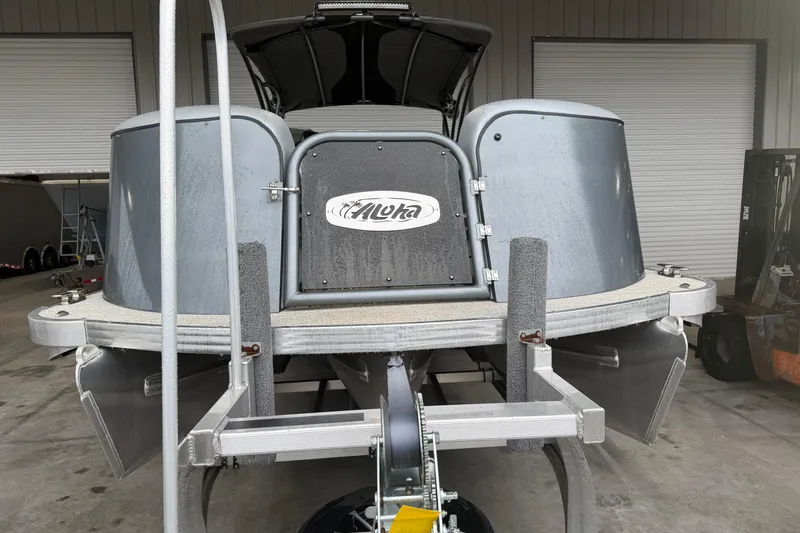 Slide: The Image of 2023 Aloha Pontoon PS 260 TT boat in a garage, rear view. - 11