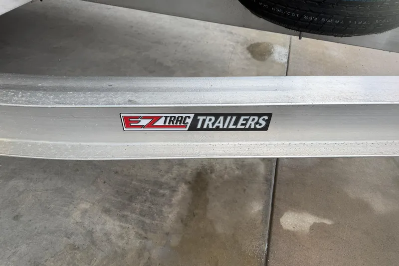 Slide: The Image of EZ Trac Trailers logo on a 2023 Aloha Pontoon PS 260 TT trailer frame. - 13
