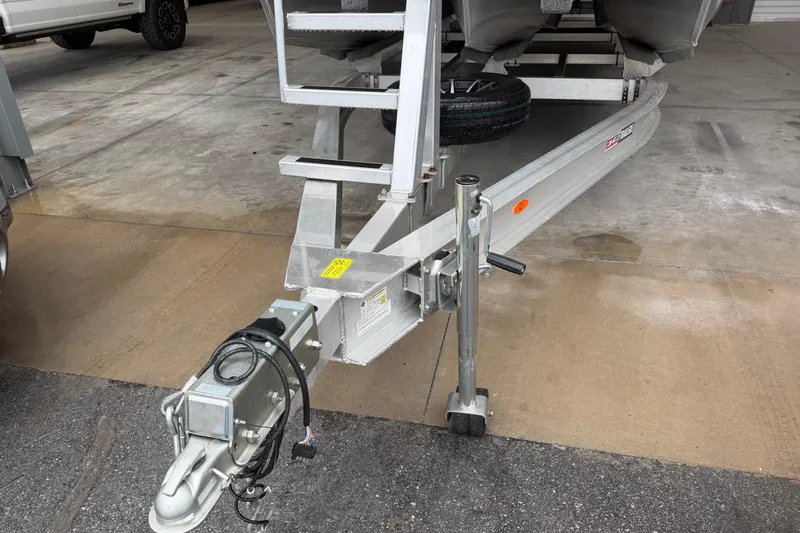 Slide: The Image of Trailer hitch of 2023 Aloha Pontoon PS 260 TT in a garage setting. - 16