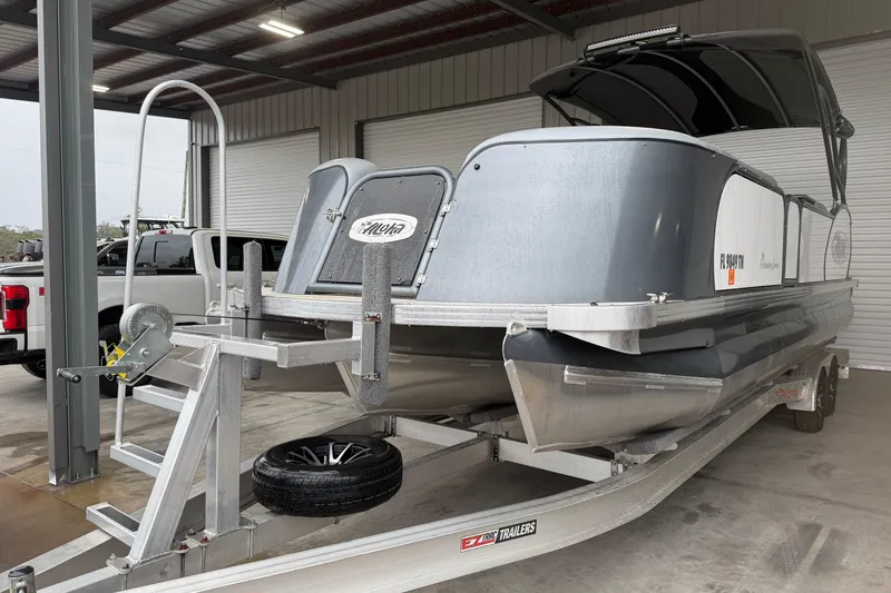 Slide: The Image of 2023 Aloha Pontoon PS 260 TT on trailer in covered storage area. - 17