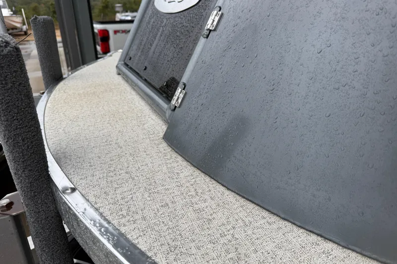 Slide: The Image of 2023 Aloha Pontoon PS 260 TT with rain-soaked deck and sleek design. - 20