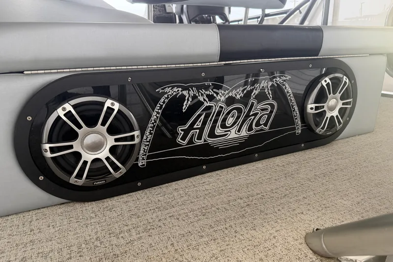 Slide: The Image of 2023 Aloha Pontoon PS 260 TT with custom speaker panel featuring palm tree design. - 21