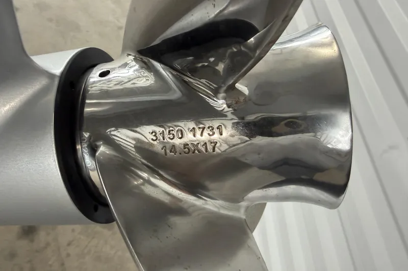 Slide: The Image of Close-up of a 2023 Aloha Pontoon PS 260 TT propeller with engraved specifications. - 23