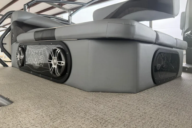 Slide: The Image of 2023 Aloha Pontoon PS 260 TT interior with sleek seating and integrated speakers. - 25