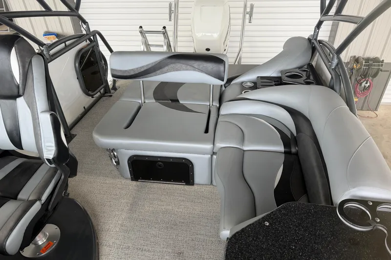 Slide: The Image of 2023 Aloha Pontoon PS 260 TT interior with gray seating and cup holders. - 28