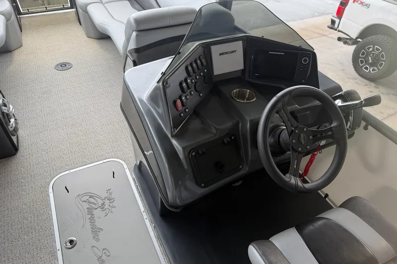 Slide: The Image of 2023 Aloha Pontoon PS 260 TT interior with steering console and seating. - 32
