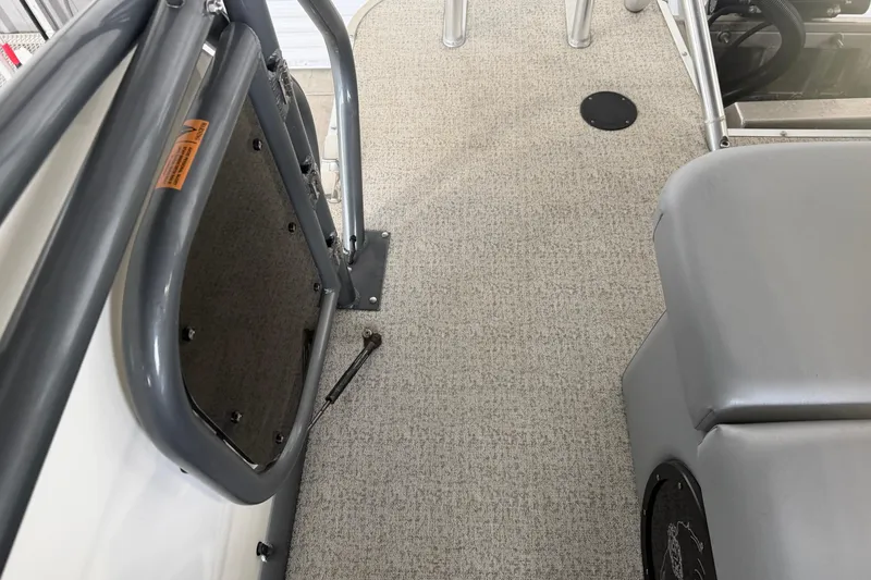 Slide: The Image of 2023 Aloha Pontoon PS 260 TT interior with gray seating and carpeted flooring. - 37