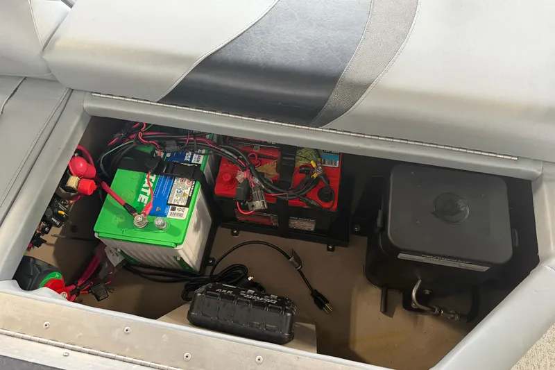 Slide: The Image of 2023 Aloha Pontoon PS 260 TT battery compartment with wiring and components. - 42