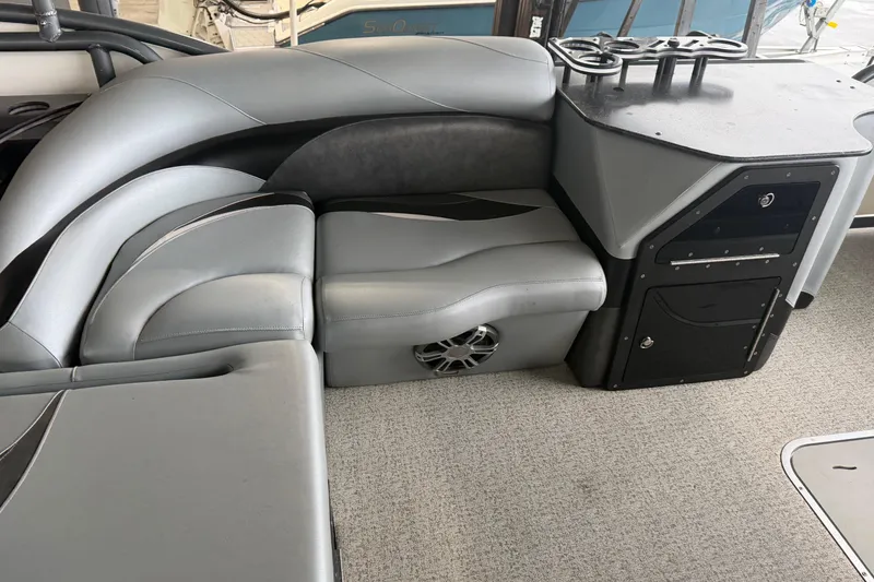 Slide: The Image of 2023 Aloha Pontoon PS 260 TT interior with gray seating and storage compartments. - 47