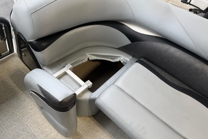 Slide: The Image of 2023 Aloha Pontoon PS 260 TT interior seating with storage compartment open. - 67