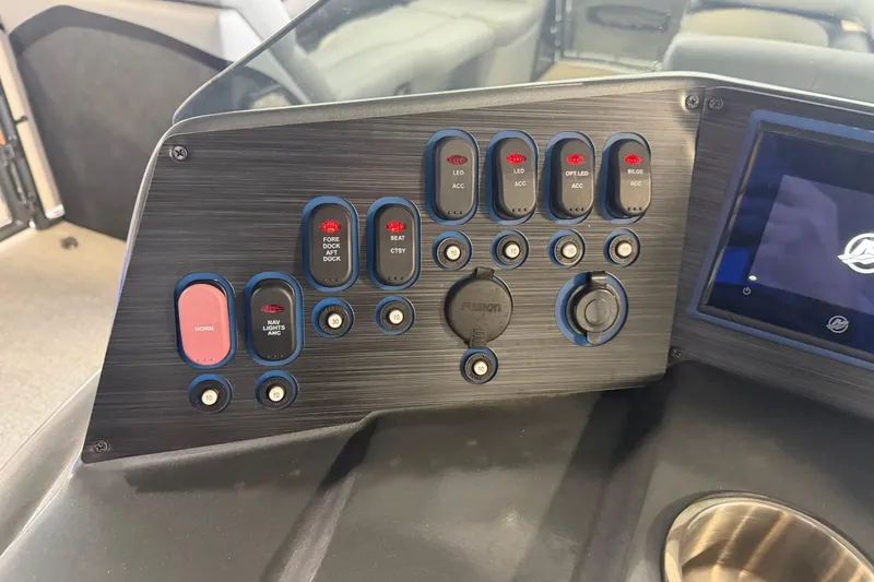 Slide: The Image of Control panel of 2023 Aloha Pontoon PS 260 TT with switches and display screen. - 74