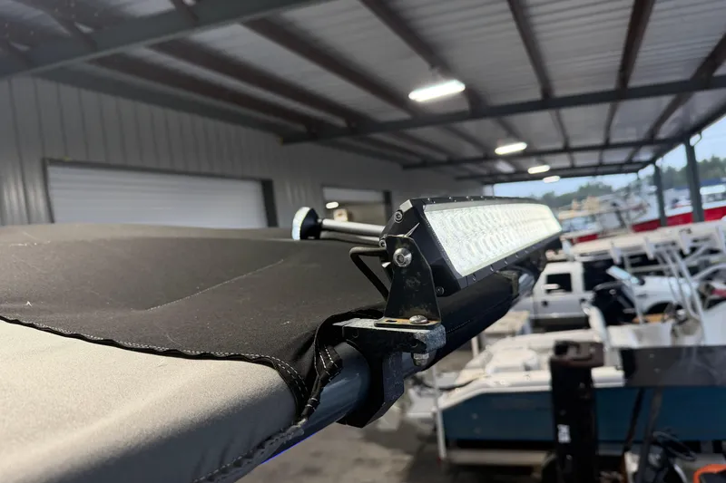 Slide: The Image of 2023 Aloha Pontoon PS 260 TT with LED light bar in a covered storage area. - 83