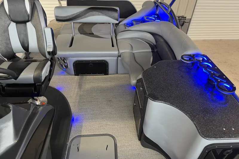 Slide: The Image of 2023 Aloha Pontoon PS 260 TT interior with modern seating and blue LED lighting. - 84
