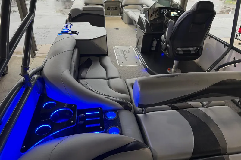 Slide: The Image of 2023 Aloha Pontoon PS 260 TT interior with blue LED lighting and luxurious seating. - 91