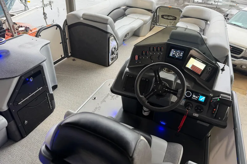 Slide: The Image of 2023 Aloha Pontoon PS 260 TT interior with modern dashboard and spacious seating. - 93