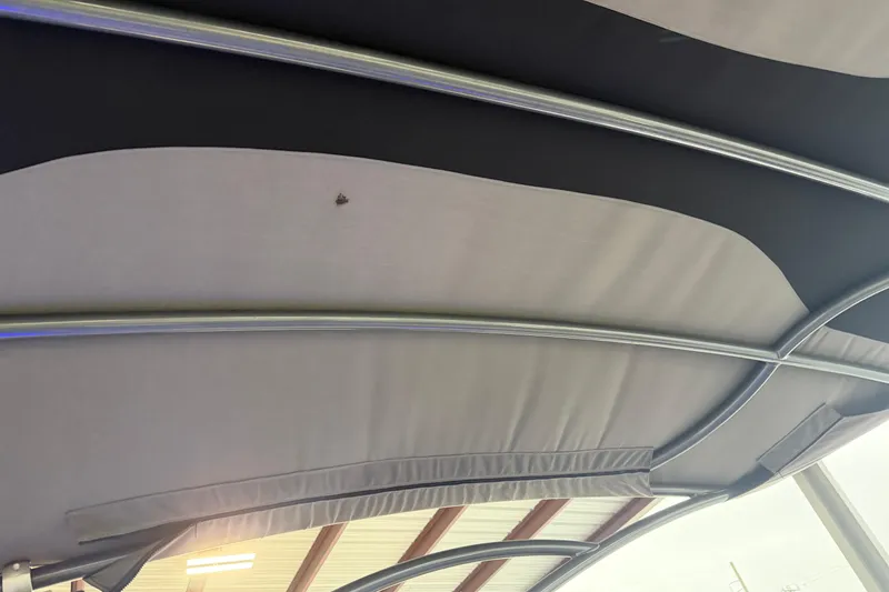 Slide: The Image of 2023 Aloha Pontoon PS 260 TT canopy with metal frame, indoor setting. - 95