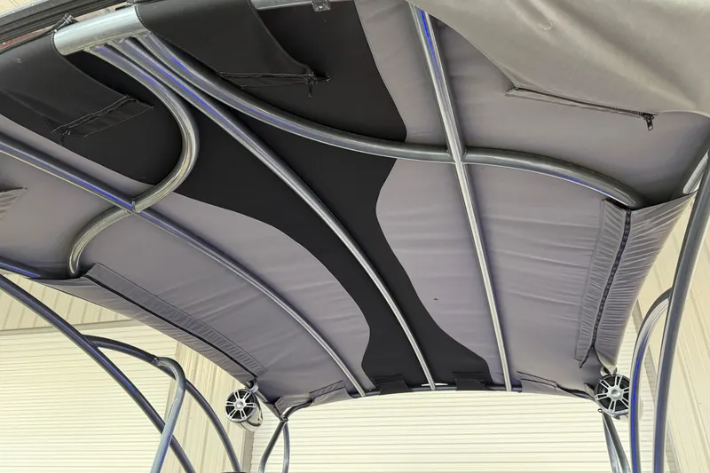 Slide: The Image of 2023 Aloha Pontoon PS 260 TT canopy with sleek metal frame and integrated speakers. - 97