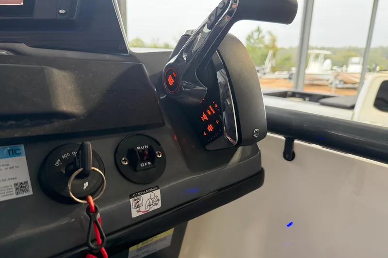 Slide: The Image of Control panel of 2023 Aloha Pontoon PS 260 TT with ignition and throttle lever. - 98