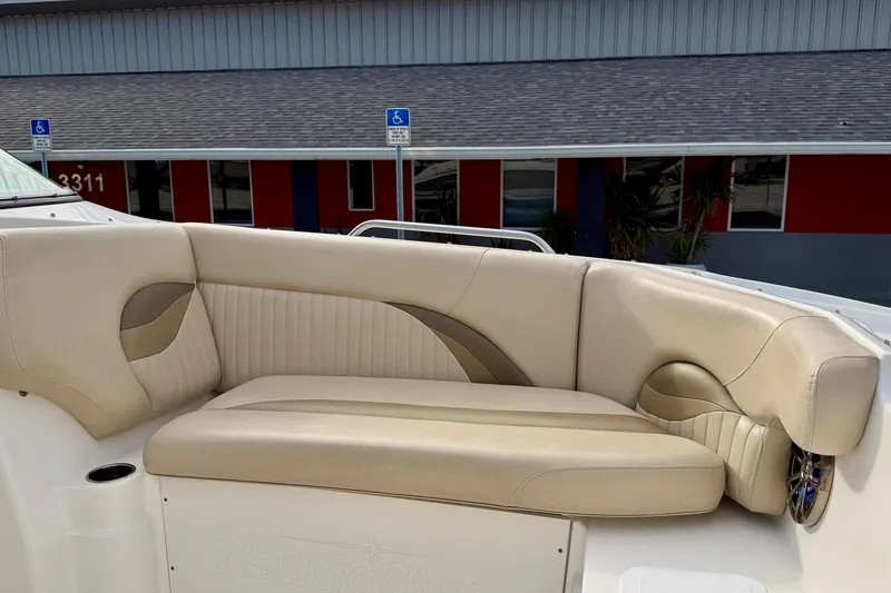 Slide: The Image of 2014 NauticStar 223DC Sport Deck boat with beige seating and modern design. - 10