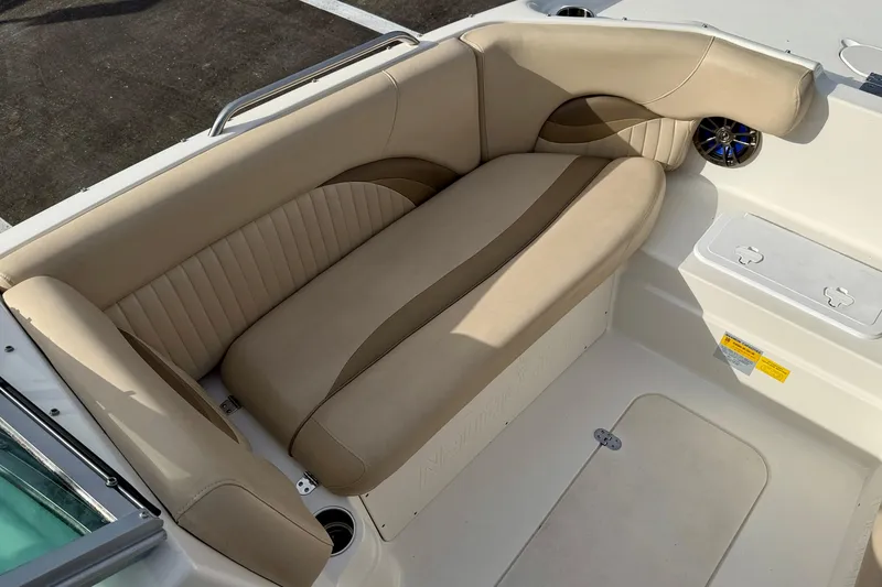 Slide: The Image of 2014 NauticStar 223DC Sport Deck boat with beige seating and speaker detail. - 12