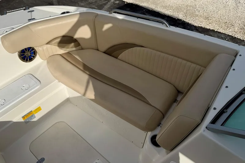 Slide: The Image of 2014 NauticStar 223DC Sport Deck boat with beige seating and speaker detail. - 13