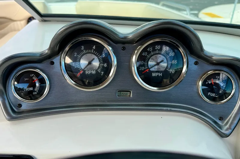 Slide: The Image of Dashboard of 2014 NauticStar 223DC Sport Deck showing RPM, speed, trim, and fuel gauges. - 16