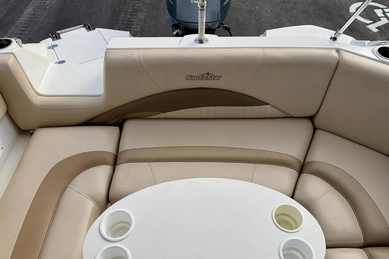Slide: The Image of 2014 NauticStar 223DC Sport Deck boat interior with beige seating and cup holders. - 26