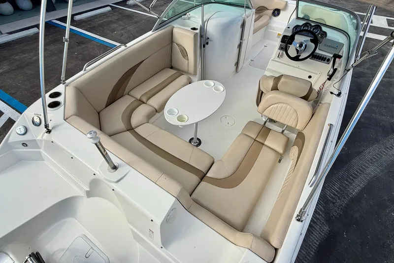 Slide: The Image of 2014 NauticStar 223DC Sport Deck boat interior with beige seating and steering console. - 29