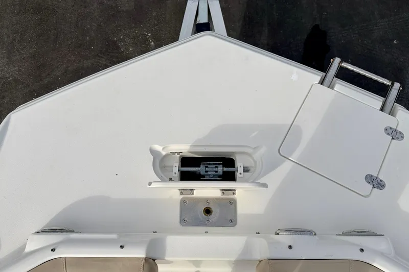 Slide: The Image of 2014 NauticStar 223DC Sport Deck boat bow with anchor storage and ladder. - 35