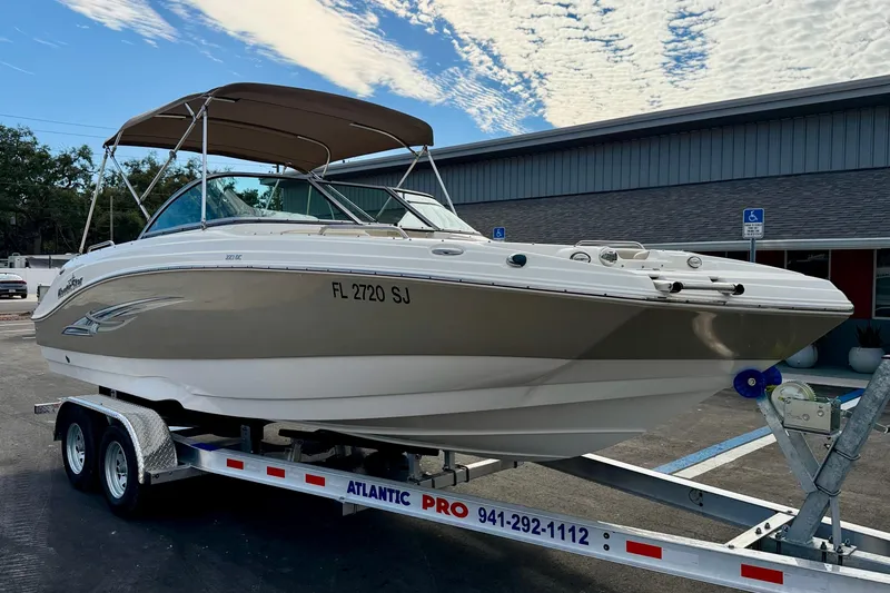 Slide: The Image of 2014 NauticStar 223DC Sport Deck boat on trailer, parked outdoors. - 4