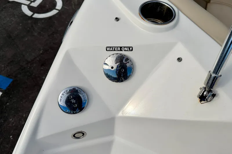 Slide: The Image of 2014 NauticStar 223DC Sport Deck boat with water and waste caps. - 44