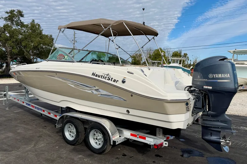 Slide: The Image of 2014 NauticStar 223DC Sport Deck boat on trailer with Yamaha outboard motor. - 5