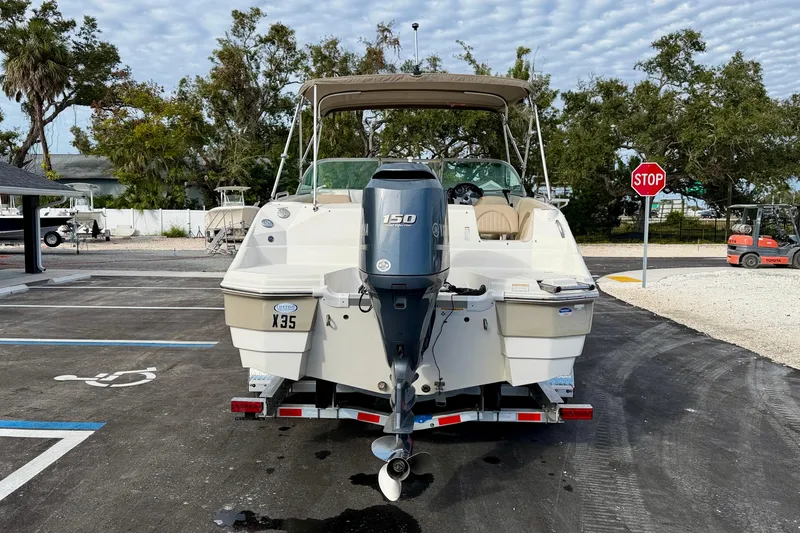 Slide: The Image of 2014 NauticStar 223DC Sport Deck boat with Yamaha 150 engine, parked outdoors. - 6