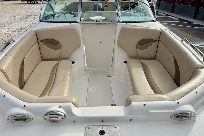 Slide: The Image of 2014 NauticStar 223DC Sport Deck boat interior with beige seating and white deck. - 8