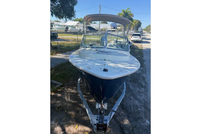 Slide: The Image of Interior of a 2004 Holby Pilot 19 boat with steering wheel and seating. - 3