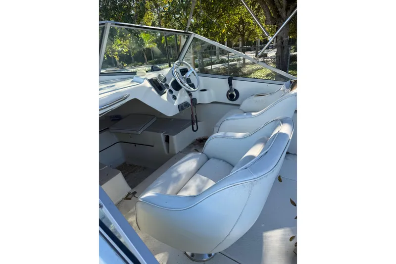 Slide: The Image of Interior view of a 2004 Holby Pilot 19 boat cockpit with steering wheel and controls. - 4